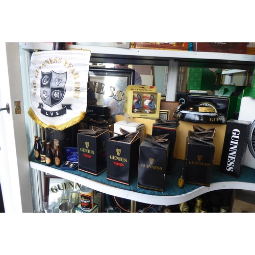 123 - An extensive collection of Guinness memorabilia: to include unopened bottles, commemorating various ... 