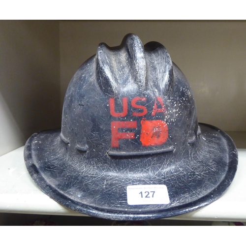 127 - A fibreglass fire fighters helmet, branded for USA(Please Note: this lot is subject to the statement... 