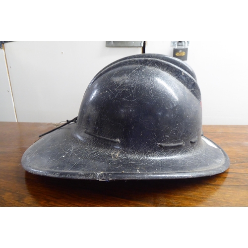 127 - A fibreglass fire fighters helmet, branded for USA(Please Note: this lot is subject to the statement... 