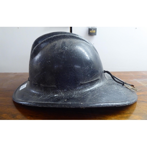 127 - A fibreglass fire fighters helmet, branded for USA(Please Note: this lot is subject to the statement... 