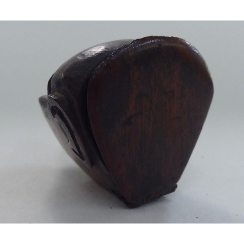 135 - An 18thC walnut novelty snuff box, naively carved as a monkeys head with a hinged lid