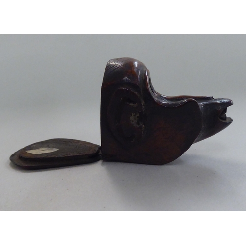 135 - An 18thC walnut novelty snuff box, naively carved as a monkeys head with a hinged lid