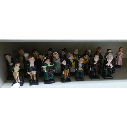 14 - Twenty-four Royal Doulton china figures from the Charles Dickens series: to include 'Fagin'; 'Artful... 