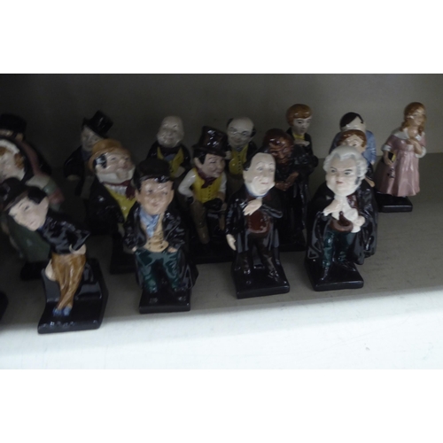 14 - Twenty-four Royal Doulton china figures from the Charles Dickens series: to include 'Fagin'; 'Artful... 