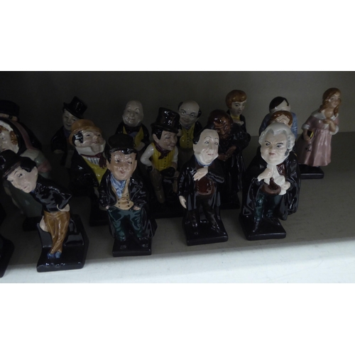 14 - Twenty-four Royal Doulton china figures from the Charles Dickens series: to include 'Fagin'; 'Artful... 