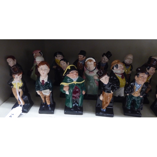 14 - Twenty-four Royal Doulton china figures from the Charles Dickens series: to include 'Fagin'; 'Artful... 