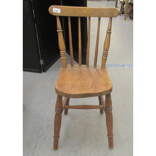 145 - A child's early 20thC Windsor beech and elm framed chair, the solid seat raised on ring turned, tape... 