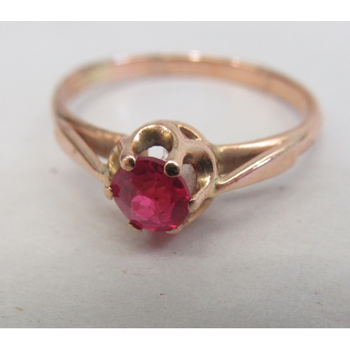 148 - A 14ct gold ring, set with a single red stone