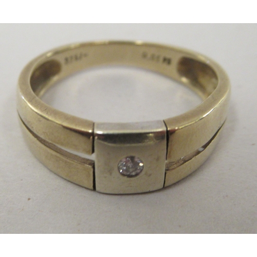 150 - A 9ct bi-coloured gold ring, set with a central diamond