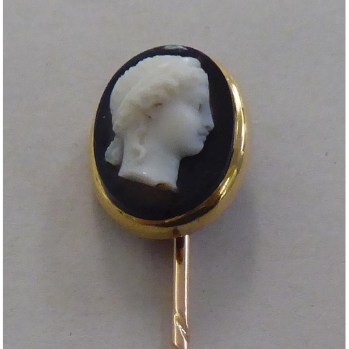 169 - A gold coloured metal cameo stickpin  cased; and a brooch, set with amethyst coloured stones&nb... 