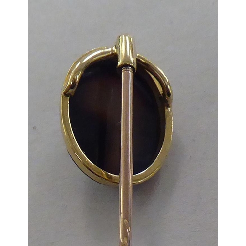 169 - A gold coloured metal cameo stickpin  cased; and a brooch, set with amethyst coloured stones&nb... 