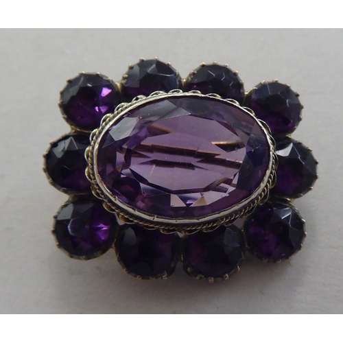 169 - A gold coloured metal cameo stickpin  cased; and a brooch, set with amethyst coloured stones&nb... 