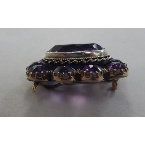 169 - A gold coloured metal cameo stickpin  cased; and a brooch, set with amethyst coloured stones&nb... 