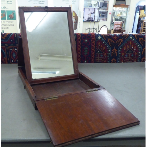 173 - A 20thC Chinese elm box design mirror, folding into a base, incorporating a ratchet  16