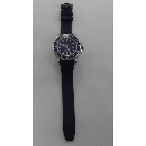 17 - A stainless steel and enamel cased wristwatch, faced by a baton dial, on a black rubber strap