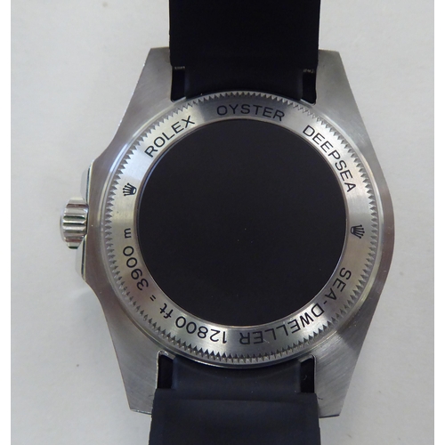 17 - A stainless steel and enamel cased wristwatch, faced by a baton dial, on a black rubber strap