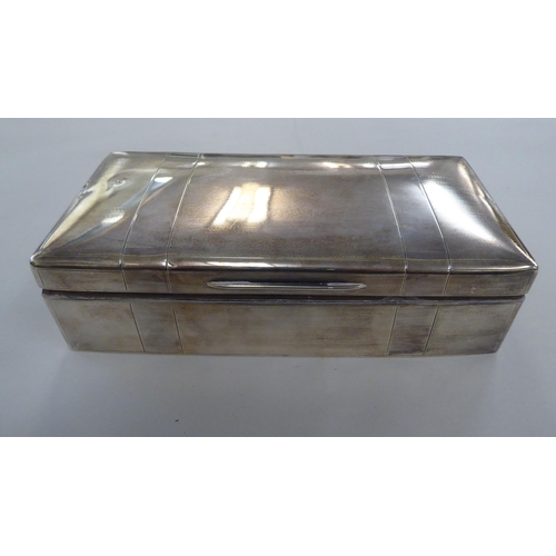 191 - A silver cigarette box with textured decoration and a hinged lid, enclosing a cedar lined interior&n... 