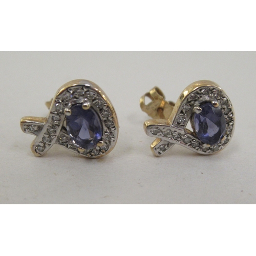 203 - A pair of yellow metal tanzanite and diamond set earrings