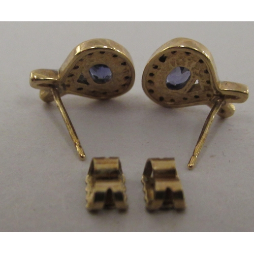 203 - A pair of yellow metal tanzanite and diamond set earrings