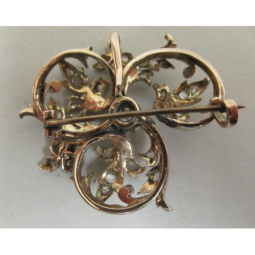 204 - A yellow metal floral brooch, set with diamonds