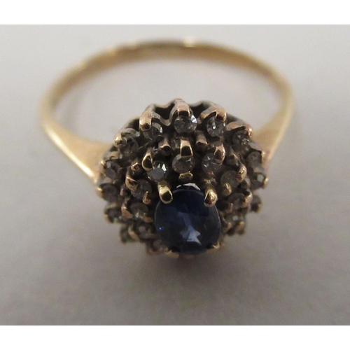 210 - A 9ct gold cluster ring, set with a central sapphire, surrounded by diamonds