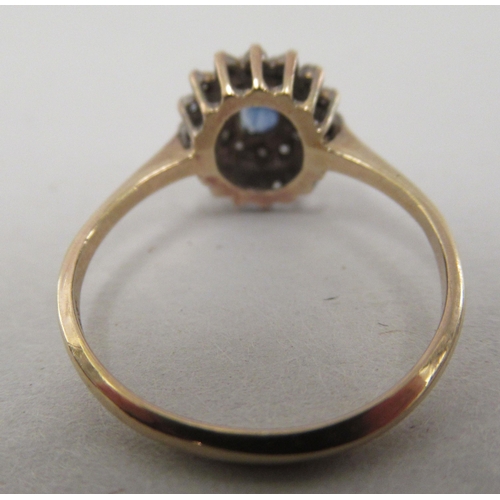 210 - A 9ct gold cluster ring, set with a central sapphire, surrounded by diamonds