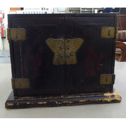 226 - A modern Chinese style bi-coloured lacquered elm table cabinet with two part-painted doors, enclosin... 