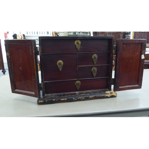 226 - A modern Chinese style bi-coloured lacquered elm table cabinet with two part-painted doors, enclosin... 