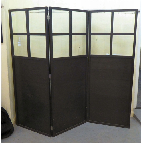 23 - A modern black ash framed three fold, glazed and panelled dressing room screen  each panel 64