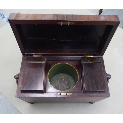 237 - A 19thC rosewood tea casket of sarcophagus form with opposing ring handles, the hinged lid enclosing... 