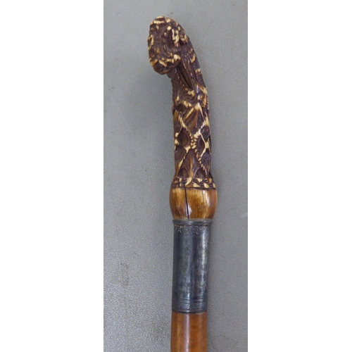 242 - Four variously decorated walking sticks: to include one in hardwood with a white metal crook handle,... 