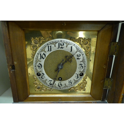 243 - An early 20thC oak cased mantel clock; the chiming movement faced by a silvered and brass Arabic dia... 