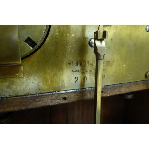 243 - An early 20thC oak cased mantel clock; the chiming movement faced by a silvered and brass Arabic dia... 