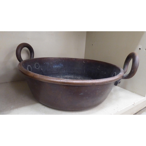 244 - An early 20thC rivetted twin handled iron and copper preserve pan  15