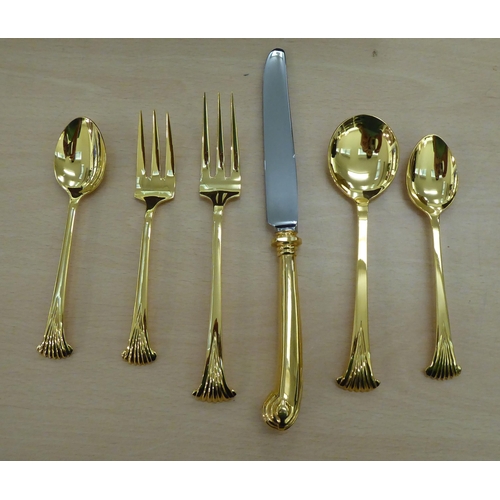 246 - Gilded, stainless steel and other matching flatware, on scrolled and pistol grip handles