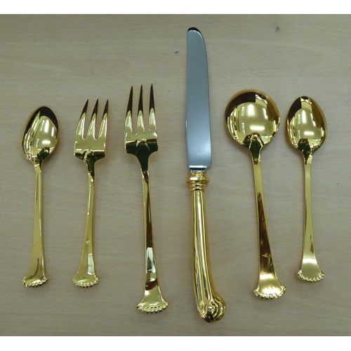 246 - Gilded, stainless steel and other matching flatware, on scrolled and pistol grip handles