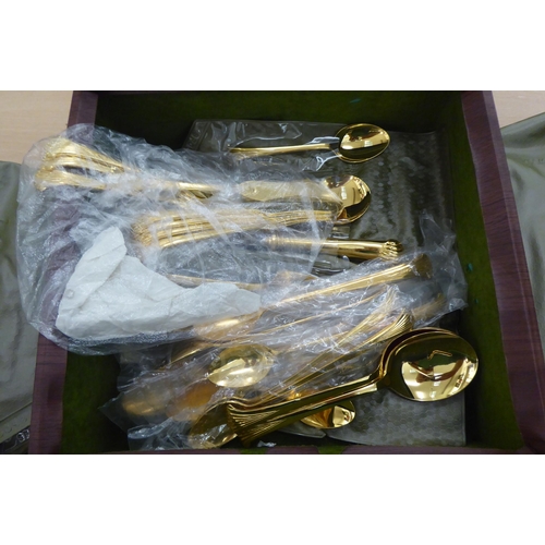 246 - Gilded, stainless steel and other matching flatware, on scrolled and pistol grip handles