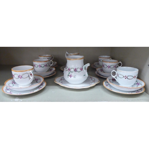 248 - A late Victorian porcelain tea set, hand painted with floral designs and orange banding  compri... 