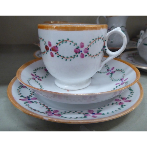 248 - A late Victorian porcelain tea set, hand painted with floral designs and orange banding  compri... 