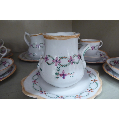 248 - A late Victorian porcelain tea set, hand painted with floral designs and orange banding  compri... 