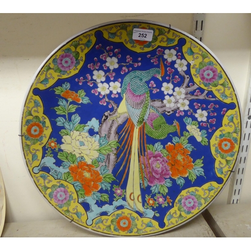 252 - A modern Japanese porcelain charger, decorated in bright colours with a peacock  18