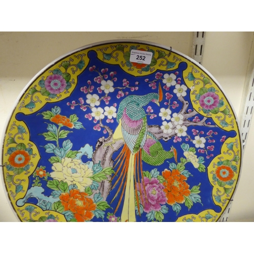 252 - A modern Japanese porcelain charger, decorated in bright colours with a peacock  18