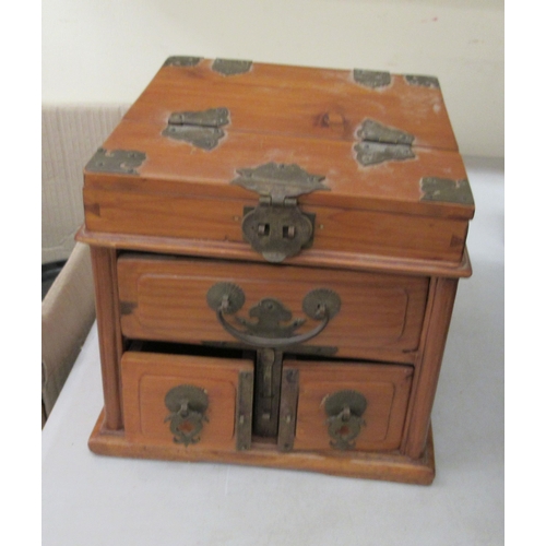 254 - A 20thC Chinese elm vanity box, incorporating a mirror, over three short drawers with brass fittings... 