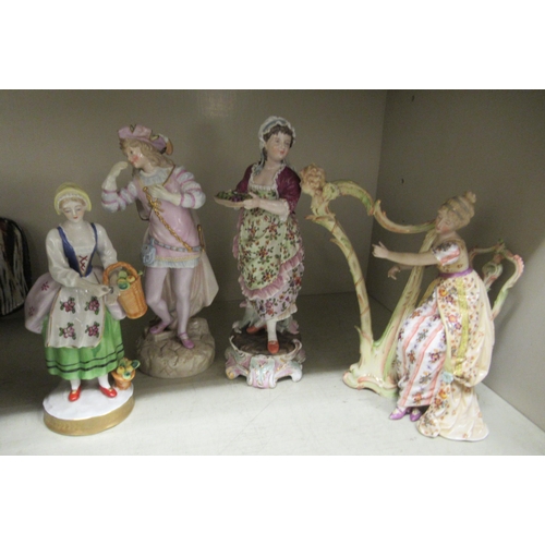 260 - Four late 19th/early 20thC European porcelain figures: to include a woman playing a harp (no string ... 