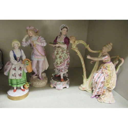 260 - Four late 19th/early 20thC European porcelain figures: to include a woman playing a harp (no string ... 