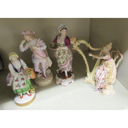 260 - Four late 19th/early 20thC European porcelain figures: to include a woman playing a harp (no string ... 