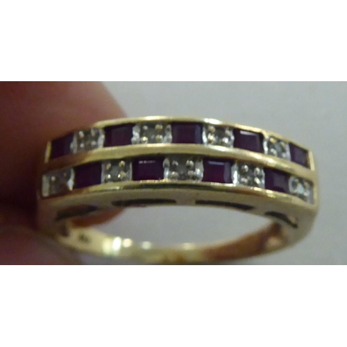 275 - A 9ct gold ring, set with two rows of alternating diamonds and rubies