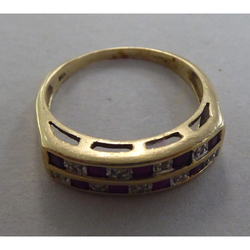 275 - A 9ct gold ring, set with two rows of alternating diamonds and rubies