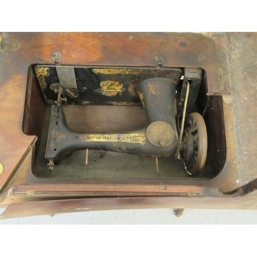 279 - An early 20thC Singer sewing machine, contained in a mahogany framed and cast iron treadle frame&nbs... 