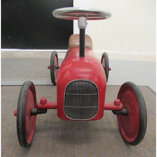 285 - A replica of a vintage red, white and black painted metal ride-on racing car